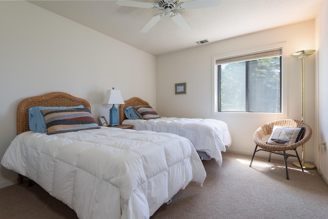 carpeted bedroom featuring visible vents and ceiling fan