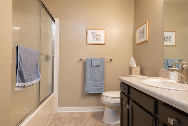 bathroom featuring tile patterned floors, toilet, baseboards, bath / shower combo with glass door, and vanity