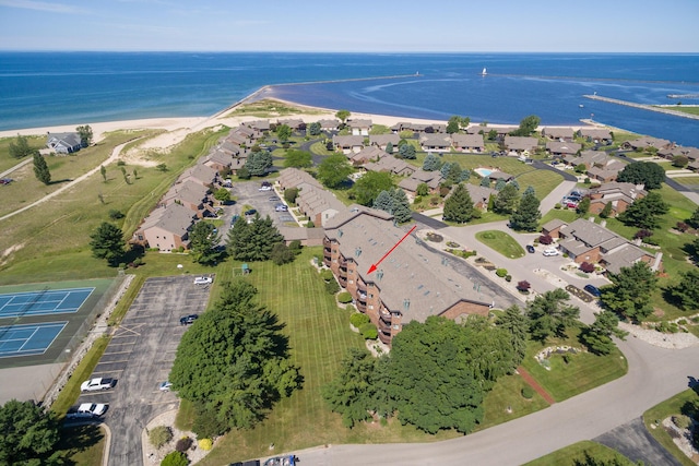 birds eye view of property with a beach view, a water view, and a residential view