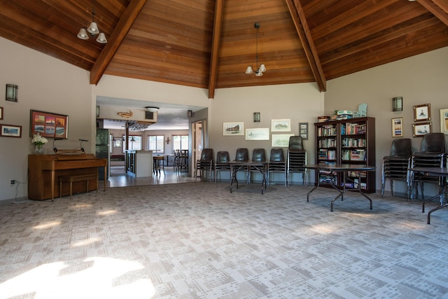 carpeted living room with beam ceiling, wooden ceiling, and high vaulted ceiling