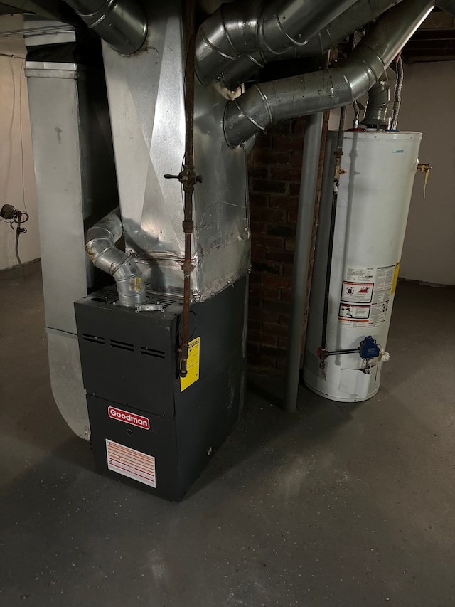 utility room featuring heating unit and water heater