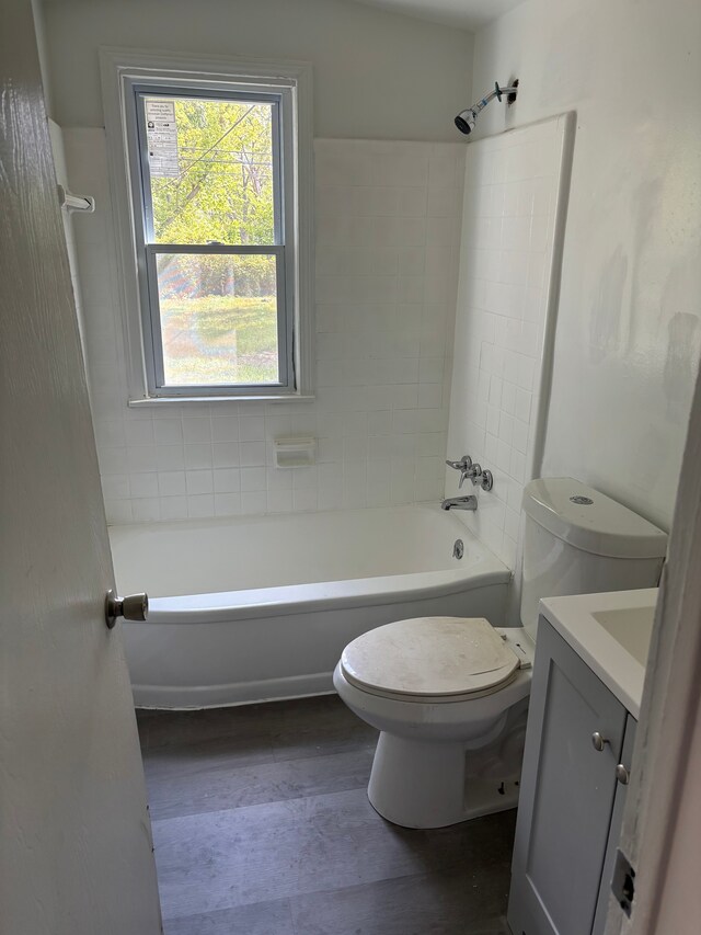 full bath with vanity, bathing tub / shower combination, toilet, and wood finished floors