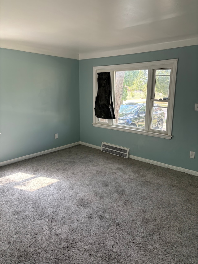 unfurnished room with carpet flooring, baseboards, and visible vents