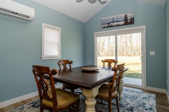 dining room with vaulted ceiling, a wall mounted air conditioner, a ceiling fan, and wood finished floors