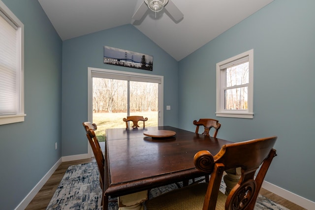 dining space featuring vaulted ceiling, plenty of natural light, ceiling fan, and wood finished floors