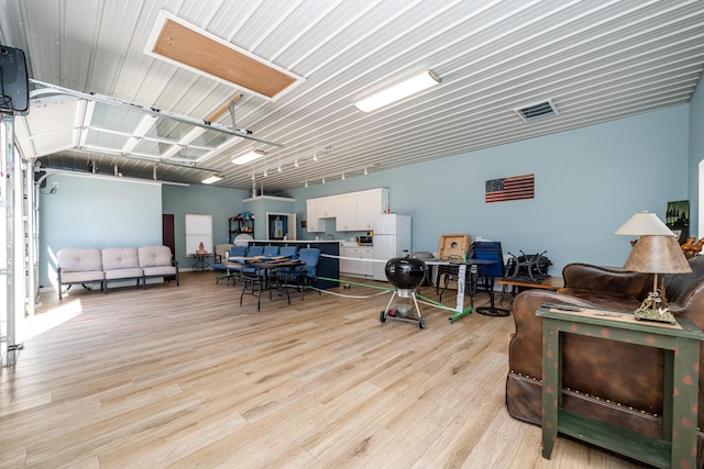 interior space with light wood-type flooring and a garage