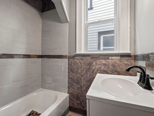 bathroom featuring tile walls and vanity