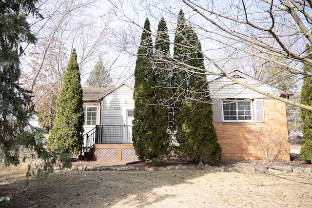 view of home's exterior with brick siding