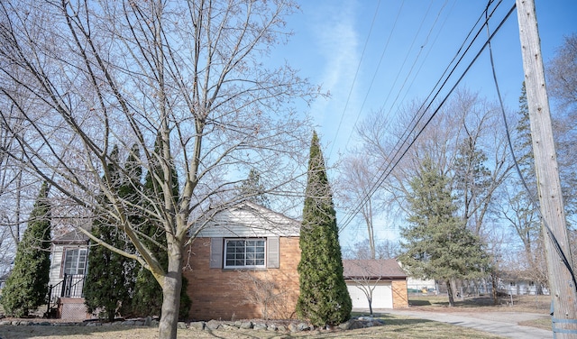 view of home's exterior featuring a garage and brick siding