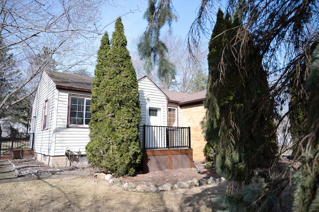 view of front of house featuring brick siding and a shingled roof