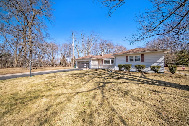 view of front of property with driveway, a front lawn, and an attached garage