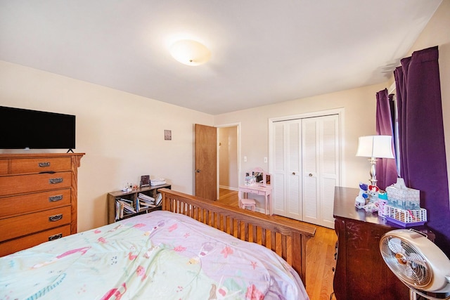 bedroom featuring a closet and light wood-style flooring