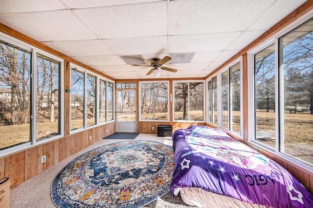 sunroom / solarium featuring a drop ceiling and ceiling fan