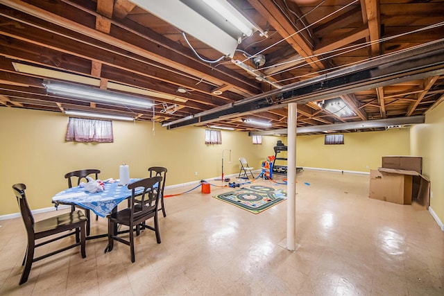 below grade area featuring baseboards and plenty of natural light