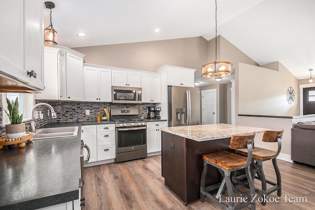 kitchen featuring a sink, dark wood-type flooring, white cabinetry, and stainless steel appliances