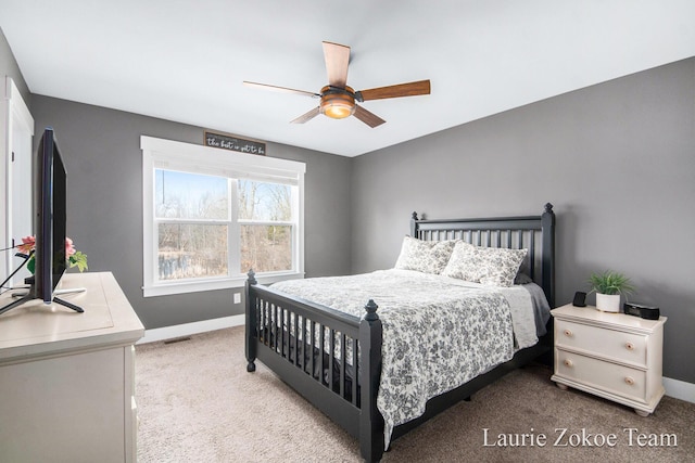 bedroom with a ceiling fan, visible vents, baseboards, and light carpet