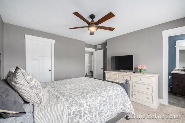 bedroom with ceiling fan, visible vents, and light carpet