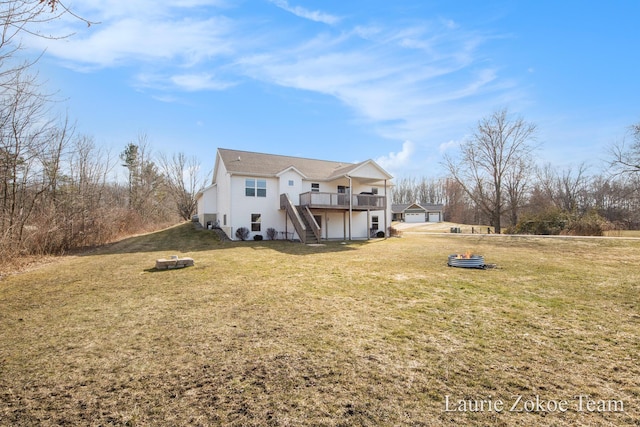 rear view of house featuring a lawn, stairs, and a deck