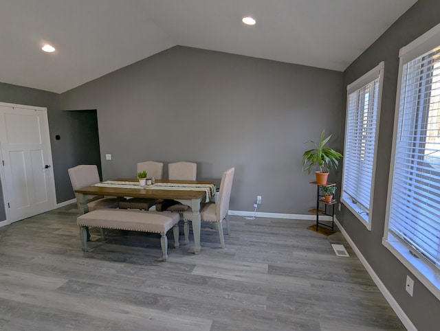 674 Booth Rd, Bronson, MI 49028 - dining area with wood finished floors, visible vents, baseboards, and lofted ceiling