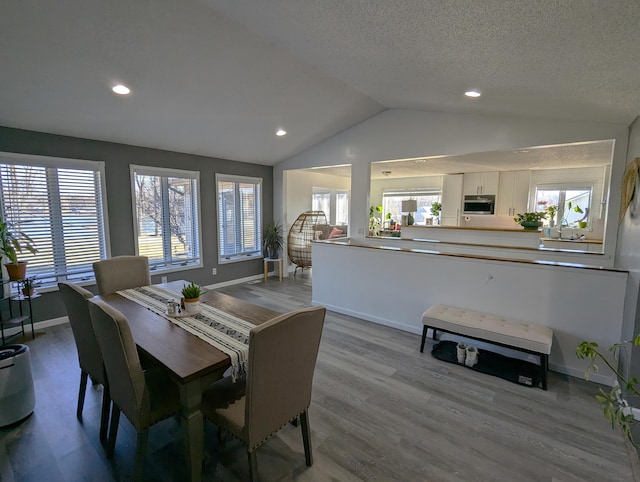 674 Booth Rd, Bronson, MI 49028 - dining area with wood finished floors, baseboards, lofted ceiling, and recessed lighting