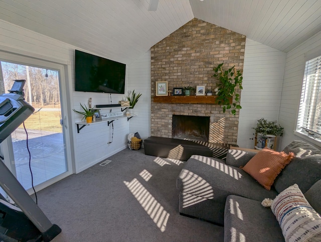 674 Booth Rd, Bronson, MI 49028 - carpeted living area with visible vents, a wealth of natural light, vaulted ceiling, and a fireplace