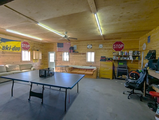 674 Booth Rd, Bronson, MI 49028 - rec room featuring wooden walls, ceiling fan, and unfinished concrete floors