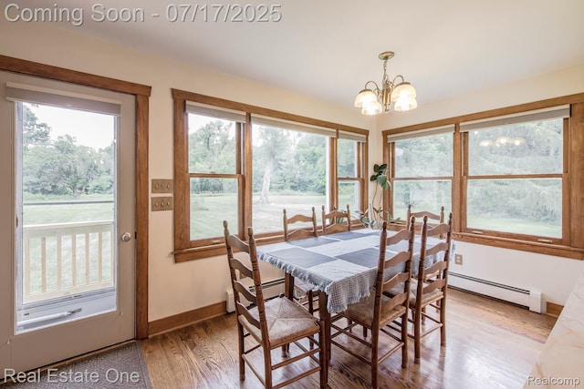 727 Romeo Rd, Rochester, MI 48307 - dining space featuring a chandelier, baseboard heating, healthy amount of natural light, and light wood-style flooring