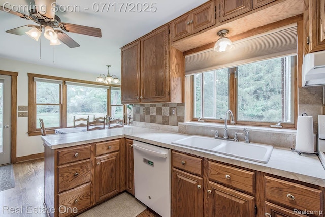 727 Romeo Rd, Rochester, MI 48307 - kitchen featuring ceiling fan, dishwasher, brown cabinetry, light countertops, and a peninsula