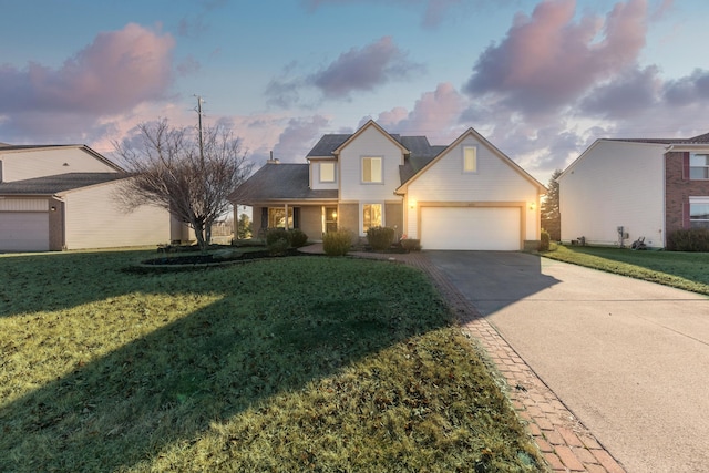 traditional-style house featuring a front yard, a garage, and driveway