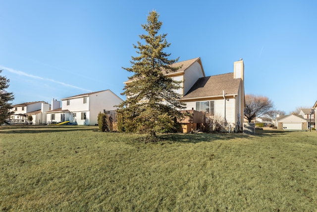 exterior space featuring a residential view, a lawn, and a chimney