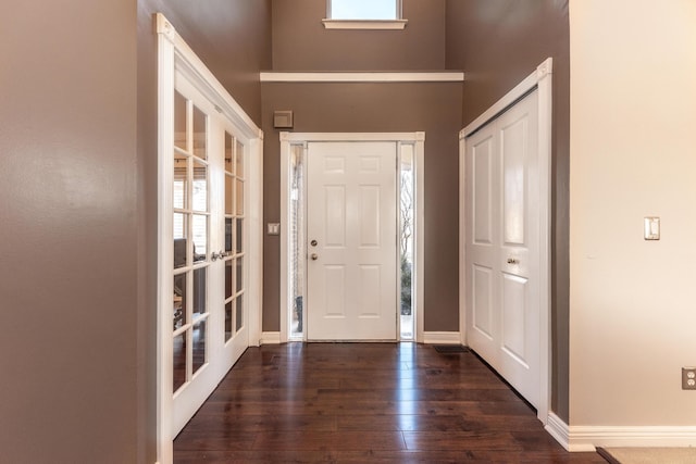 entrance foyer with french doors, baseboards, a healthy amount of sunlight, and hardwood / wood-style flooring