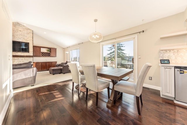 dining space with dark wood-style floors, baseboards, and lofted ceiling