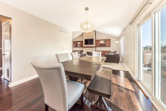 dining space featuring visible vents, baseboards, dark wood-style flooring, and vaulted ceiling
