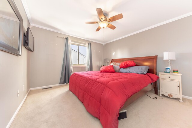 bedroom with a ceiling fan, visible vents, baseboards, ornamental molding, and light carpet