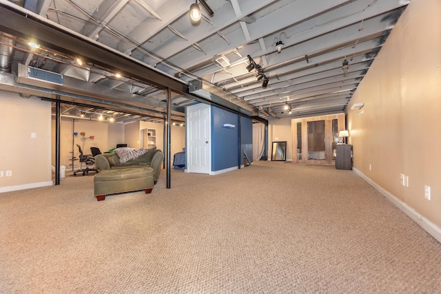 finished below grade area featuring carpet flooring and baseboards