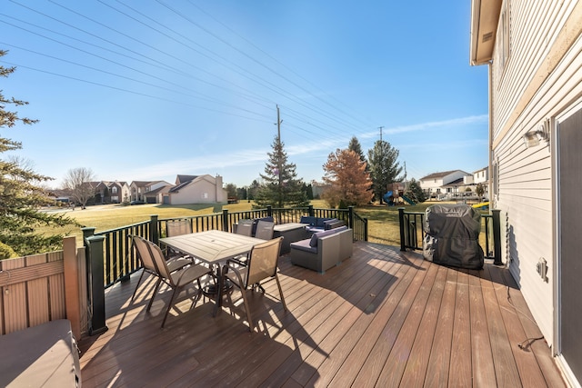 wooden terrace featuring outdoor dining area, a yard, and an outdoor hangout area