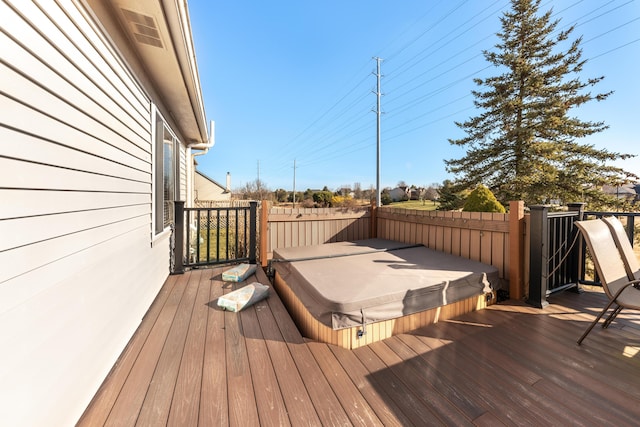 deck with a covered hot tub