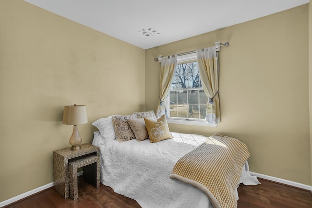 bedroom featuring baseboards and wood finished floors