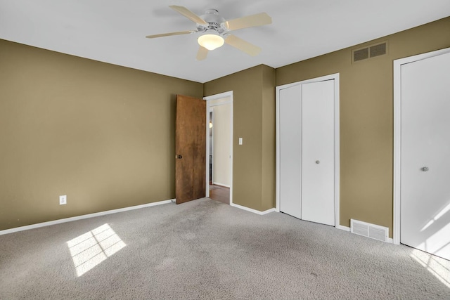 unfurnished bedroom with visible vents, a ceiling fan, carpet, and baseboards