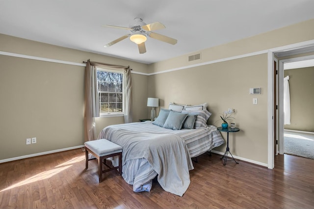 bedroom with visible vents, ceiling fan, baseboards, and wood finished floors