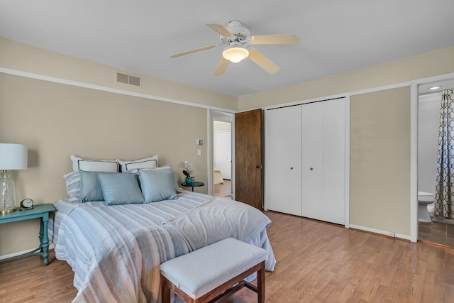 bedroom featuring ceiling fan, visible vents, a closet, and wood finished floors