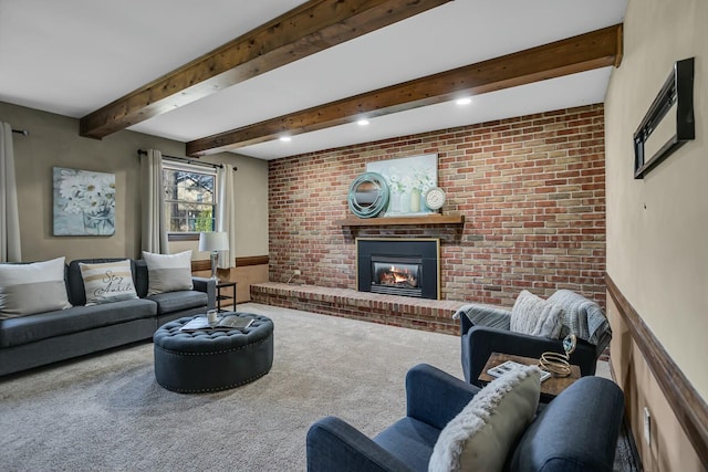 carpeted living area with beam ceiling, brick wall, and a fireplace