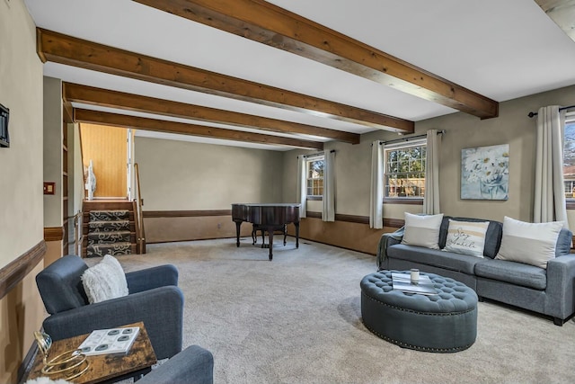 living area featuring baseboards, carpet floors, and beam ceiling