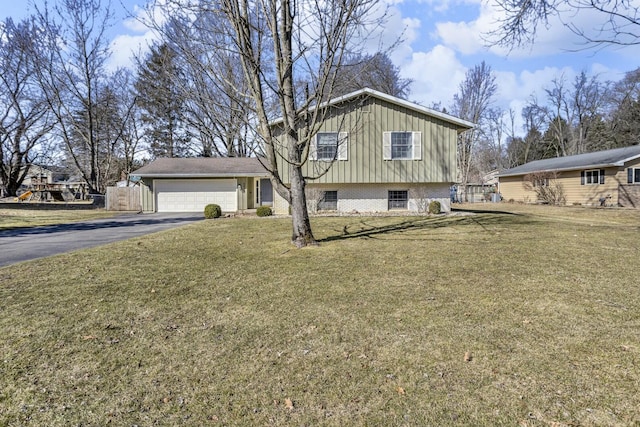 exterior space with driveway, an attached garage, and a front yard