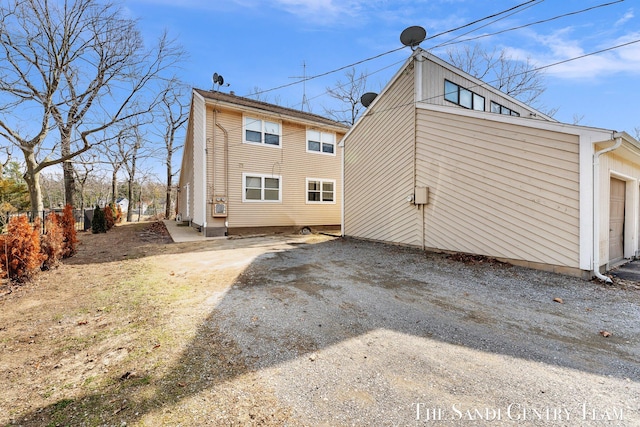 rear view of property with a garage