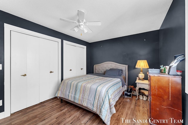 bedroom featuring a textured ceiling, ceiling fan, and wood finished floors