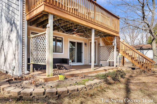 doorway to property with a patio, a deck, and a ceiling fan