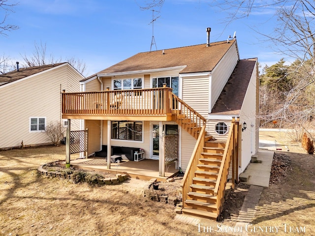 rear view of property with stairs, a deck, a patio area, and roof with shingles