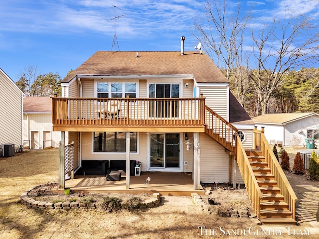 rear view of house with a shingled roof, stairway, a wooden deck, central AC unit, and a patio area