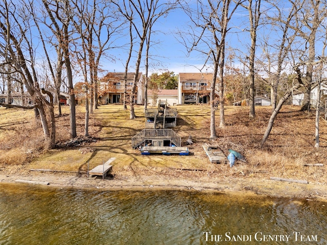 rear view of house with stairs and a water view